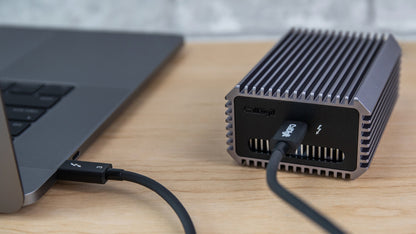 A Connect-10G on a desk connected via Thunderbolt to a computer.