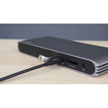USB-C HDMI Dock on a desk with a cable connected to the USB-C port, and USB flash drive connected to a USB-A port.