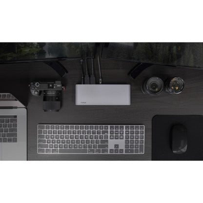 Top down view of the USB-C HDMI Dock on a desk connected to two monitors, a wireless keyboard and a MacBook Pro. A camera is also on the desk.