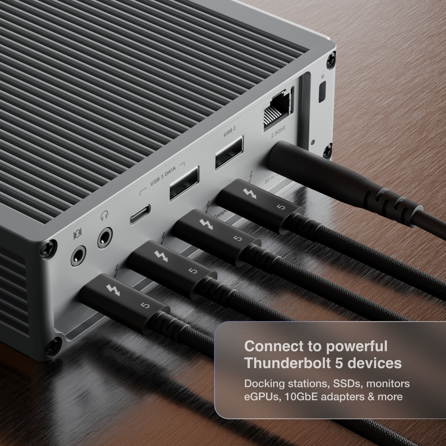An image of a dock on a desk and four Thunderbolt 5 Pro Cables connected to its Thunderbolt ports.